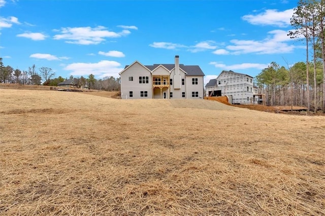 back of house featuring a yard