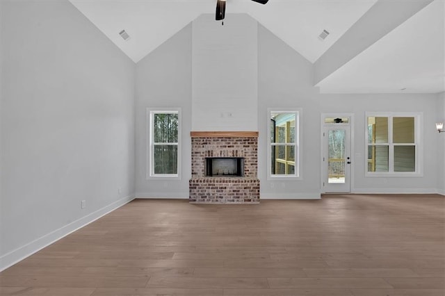 unfurnished living room featuring visible vents, ceiling fan, and wood finished floors