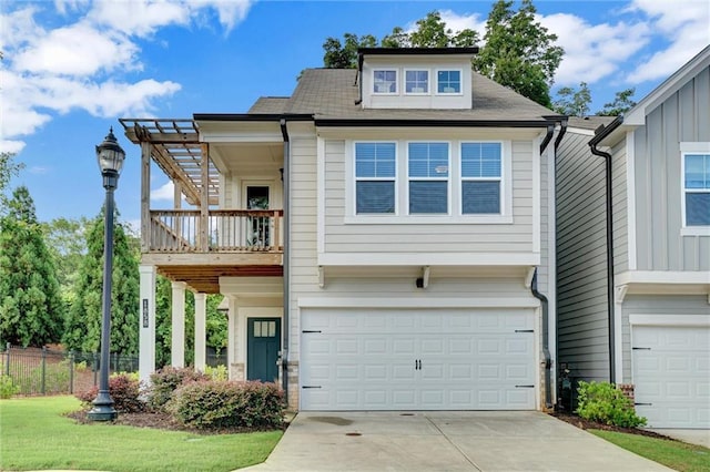 1858 Belmore St SE, Smyrna, GA 30080 - view of front of home featuring a garage, a balcony, driveway, and board and batten siding
