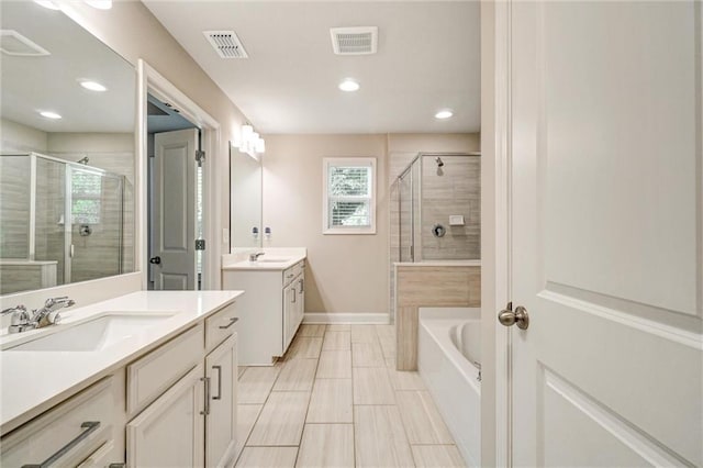 1858 Belmore St SE, Smyrna, GA 30080 - bathroom featuring a shower stall, two vanities, a bath, and recessed lighting
