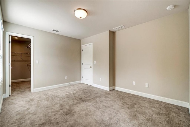 1858 Belmore St SE, Smyrna, GA 30080 - unfurnished bedroom with carpet floors, a walk in closet, and a closet