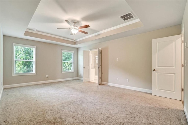 1858 Belmore St SE, Smyrna, GA 30080 - unfurnished bedroom featuring a tray ceiling, light carpet, ornamental molding, and a ceiling fan