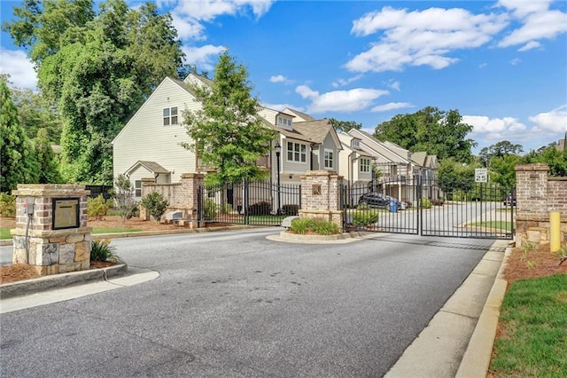 1858 Belmore St SE, Smyrna, GA 30080 - view of asphalt road with a residential view, curbs, a gate, and a gated entry