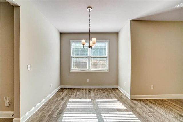 1858 Belmore St SE, Smyrna, GA 30080 - spare room with a chandelier and light wood-type flooring