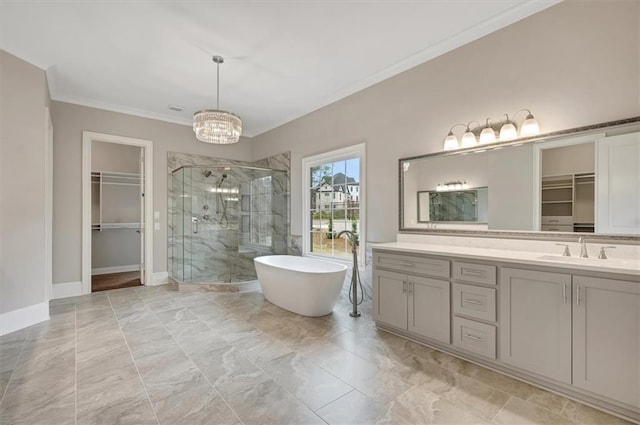 bathroom featuring a stall shower, a freestanding tub, a walk in closet, and vanity