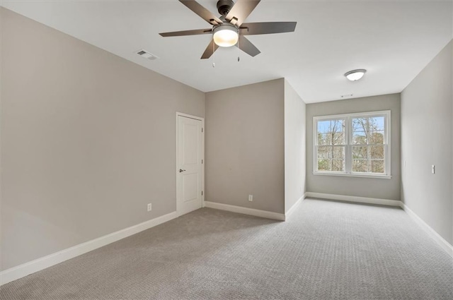 unfurnished bedroom featuring visible vents, baseboards, a ceiling fan, and light colored carpet