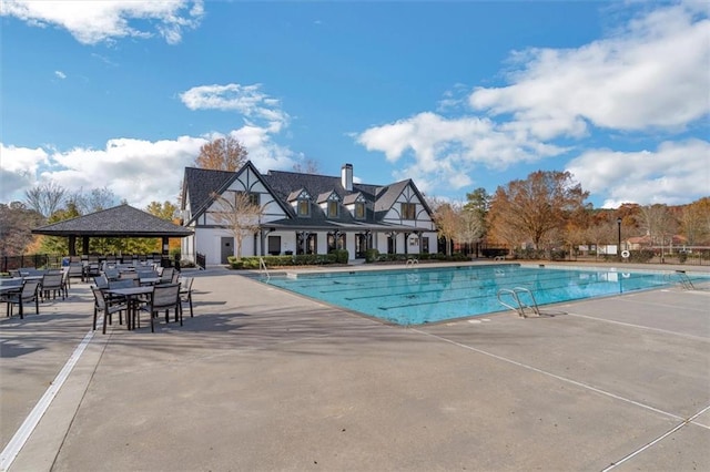 pool featuring a patio area, fence, and a gazebo