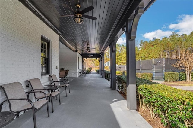 view of patio / terrace with ceiling fan and fence