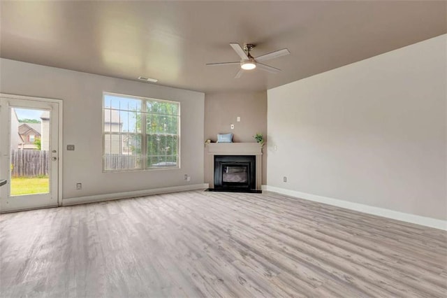 529 Dasheill Ln, Atlanta, GA 30349 - unfurnished living room featuring wood finished floors, a glass covered fireplace, and ceiling fan