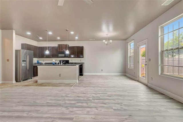 529 Dasheill Ln, Atlanta, GA 30349 - kitchen featuring high quality fridge, open floor plan, light wood-style flooring, plenty of natural light, and recessed lighting