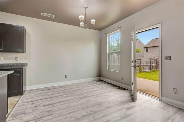 529 Dasheill Ln, Atlanta, GA 30349 - unfurnished dining area featuring light wood-style floors and a chandelier