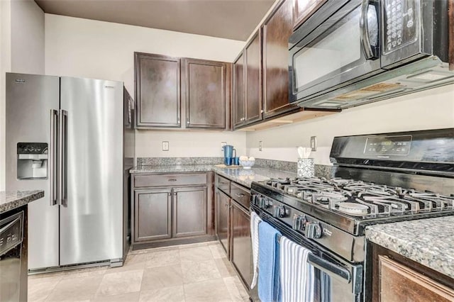 529 Dasheill Ln, Atlanta, GA 30349 - kitchen with black appliances, light stone countertops, and dark brown cabinets