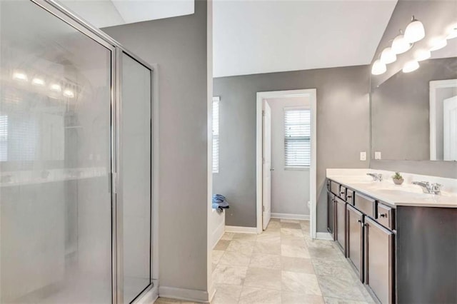 529 Dasheill Ln, Atlanta, GA 30349 - full bath featuring double vanity, a shower stall, and vaulted ceiling