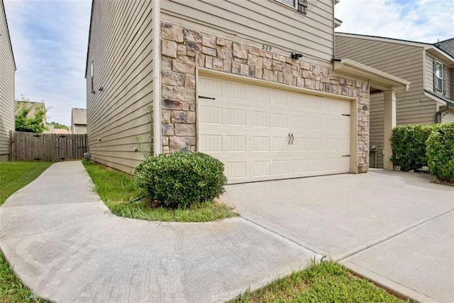 529 Dasheill Ln, Atlanta, GA 30349 - garage featuring concrete driveway