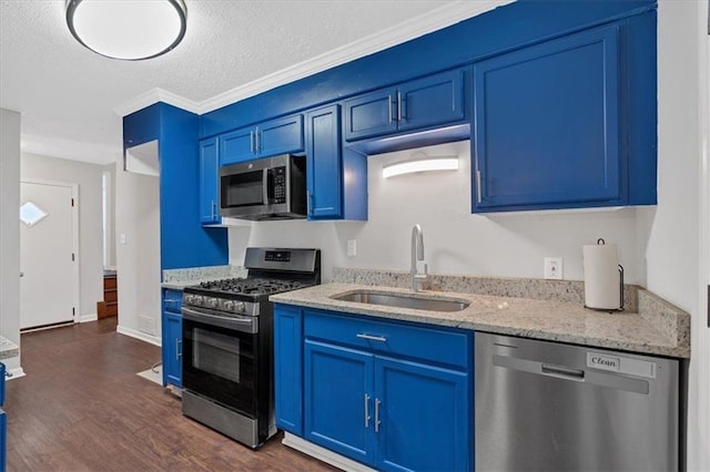 kitchen featuring light stone counters, blue cabinetry, dark wood-type flooring, sink, and stainless steel appliances