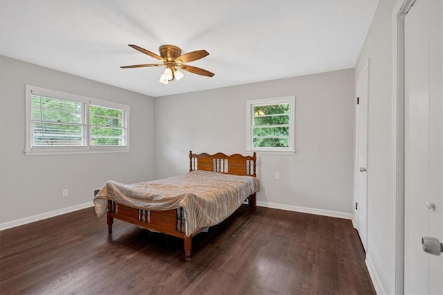 bedroom with a closet, dark hardwood / wood-style floors, and ceiling fan