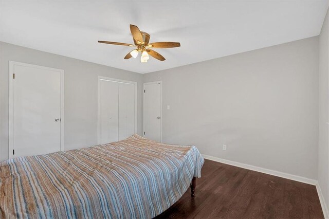 unfurnished bedroom featuring dark hardwood / wood-style floors and ceiling fan