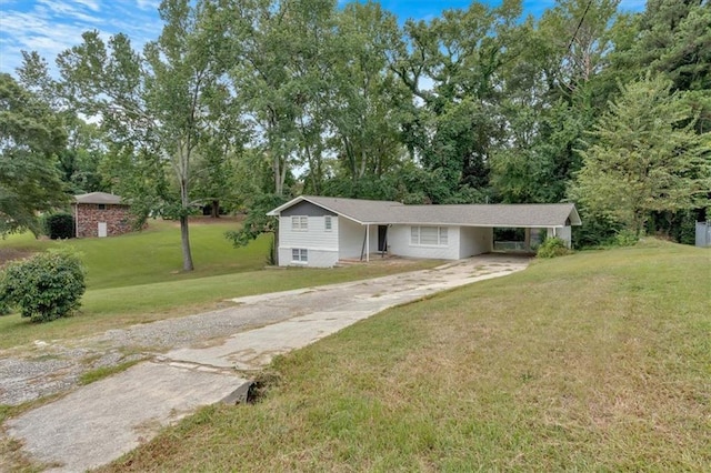 view of front of house with a carport and a front lawn