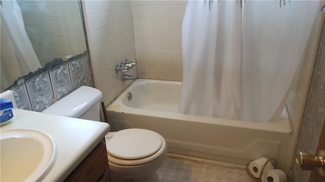 full bathroom with shower / bath combo with shower curtain, toilet, and vanity