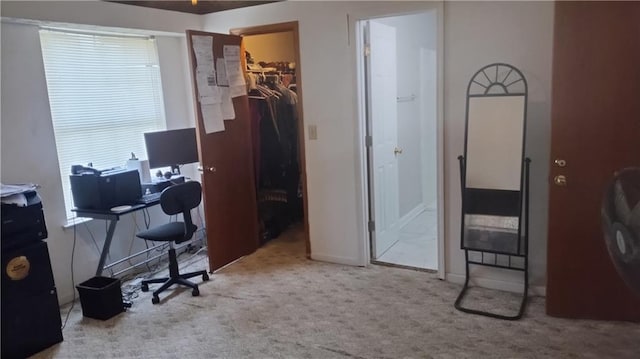 carpeted home office featuring baseboards