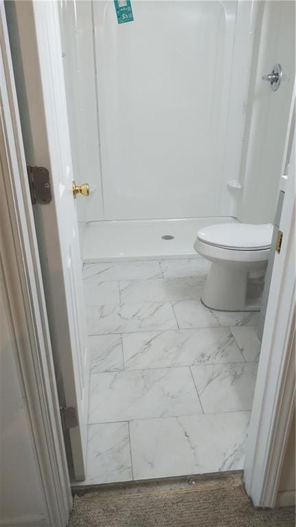 bathroom featuring walk in shower, toilet, and marble finish floor