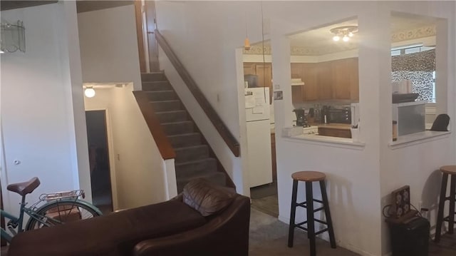 staircase featuring carpet