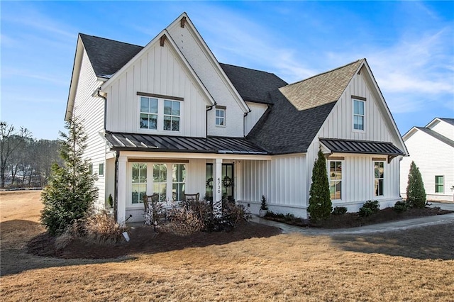 modern farmhouse featuring a front yard and a porch