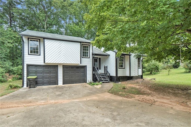 view of front of house with concrete driveway and an attached garage