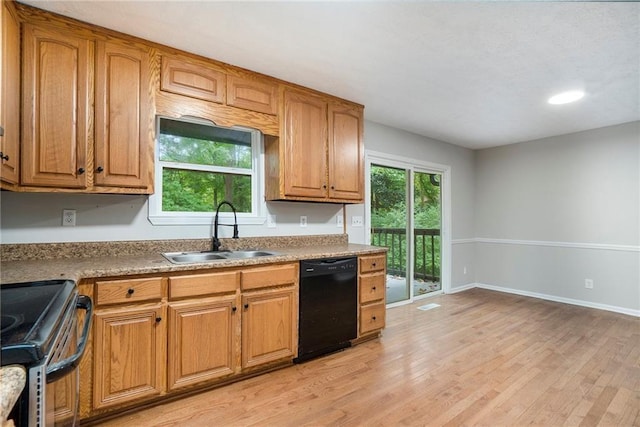 kitchen featuring a sink, light wood-style floors, stainless steel range with electric cooktop, dishwasher, and plenty of natural light