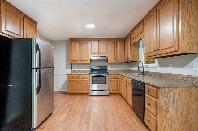 kitchen featuring stainless steel appliances, light wood-style floors, a sink, under cabinet range hood, and baseboards