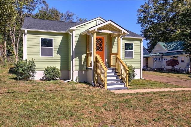 bungalow-style house with a front lawn