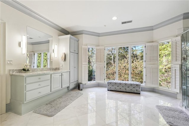 bathroom featuring a shower with door, vanity, and crown molding