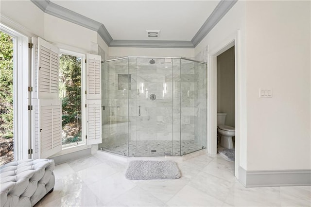 bathroom featuring an enclosed shower, ornamental molding, and toilet