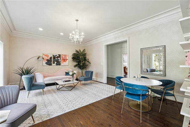 living room featuring wood-type flooring, ornamental molding, and a chandelier