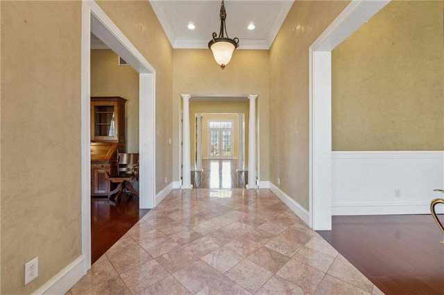 hall with recessed lighting, baseboards, crown molding, and ornate columns