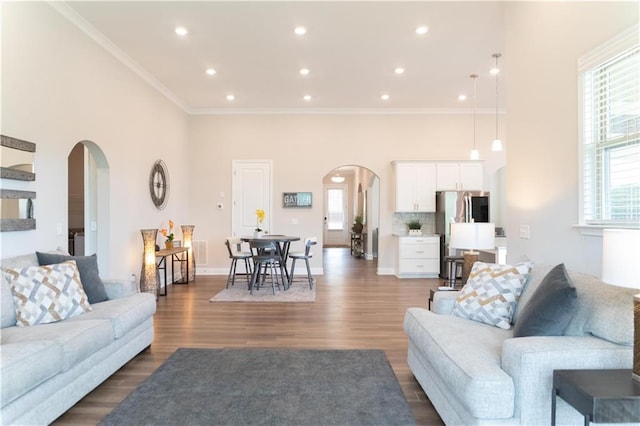 2665 Crowbrook Way, Cumming, GA 30040 - living area with arched walkways, ornamental molding, dark wood-style flooring, recessed lighting, and baseboards