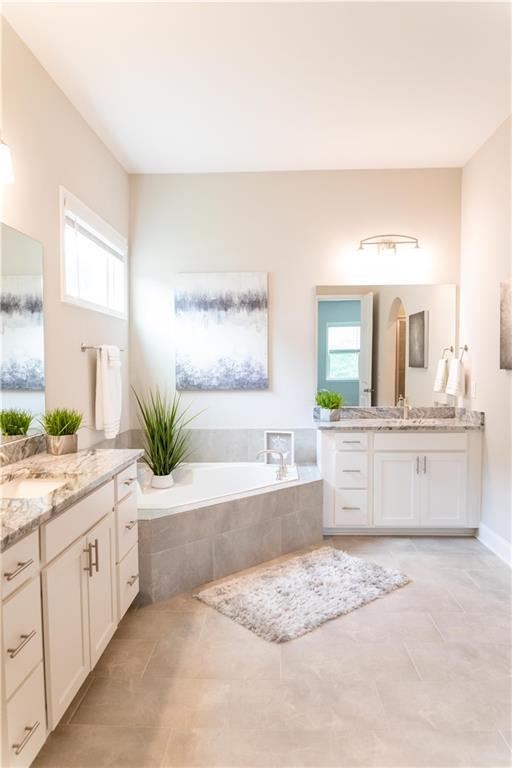 2665 Crowbrook Way, Cumming, GA 30040 - full bath with vanity, a bath, baseboards, and tile patterned floors