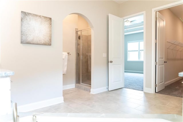 2665 Crowbrook Way, Cumming, GA 30040 - hall with arched walkways, light tile patterned floors, baseboards, and light colored carpet