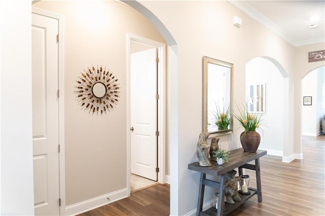 2665 Crowbrook Way, Cumming, GA 30040 - hallway with arched walkways, wood finished floors, crown molding, and baseboards