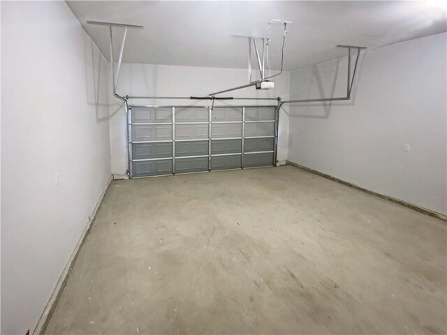 garage with a garage door opener and baseboards