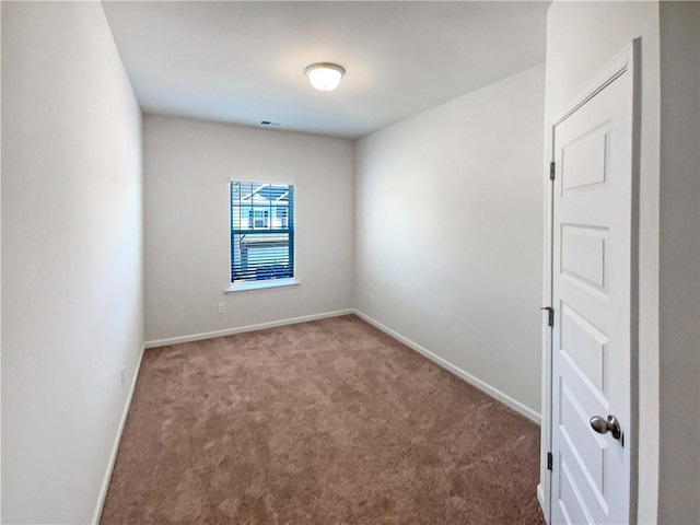 carpeted empty room with visible vents and baseboards
