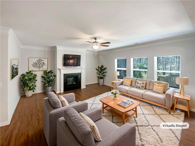 living area featuring baseboards, wood finished floors, and a ceiling fan