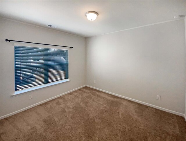 empty room with visible vents, baseboards, and carpet floors
