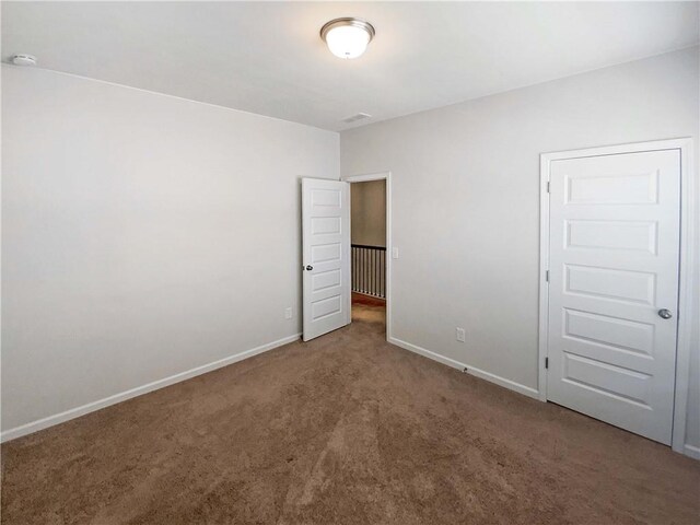 unfurnished bedroom with carpet and baseboards