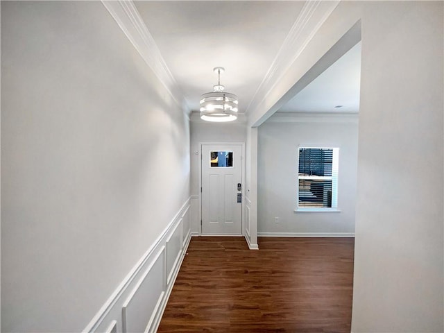 doorway with baseboards, a notable chandelier, ornamental molding, and dark wood-style flooring