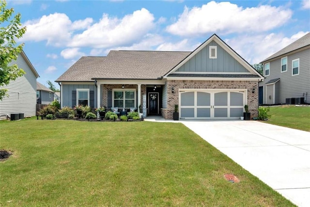 1311 Calgary Lk, Winder, GA 30680 - craftsman-style home featuring board and batten siding, brick siding, a garage, a front lawn, and driveway