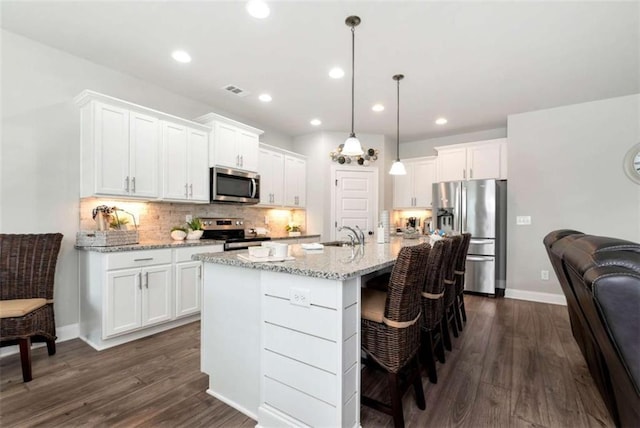 1311 Calgary Lk, Winder, GA 30680 - kitchen featuring stainless steel appliances, white cabinets, backsplash, dark wood-type flooring, and recessed lighting