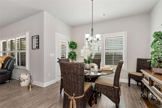 1311 Calgary Lk, Winder, GA 30680 - dining area with a chandelier and wood finished floors