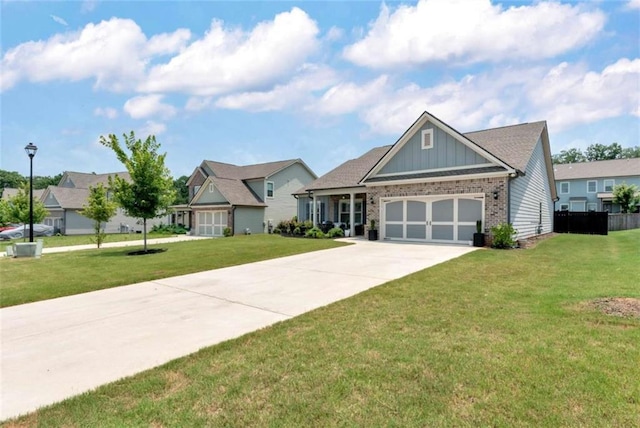 1311 Calgary Lk, Winder, GA 30680 - view of front of home with brick siding, board and batten siding, a front lawn, an attached garage, and concrete driveway