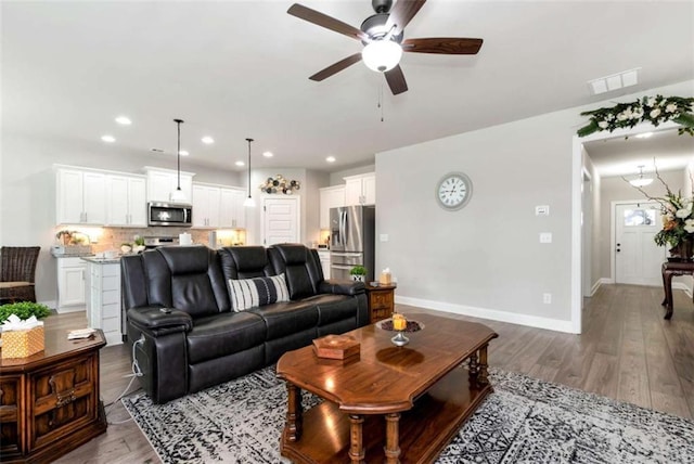 1311 Calgary Lk, Winder, GA 30680 - living room featuring a ceiling fan, wood finished floors, and recessed lighting